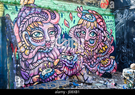 A coulrful mural by Armar por Dois on a wall in a parking area just off Brick Lane in East London. Stock Photo