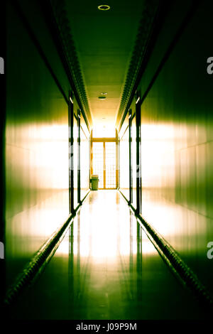 Interior of nice empty modern hotel with corridor against light Stock Photo