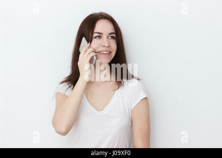 Smiling female student talking on the phone isolated on a white background Stock Photo