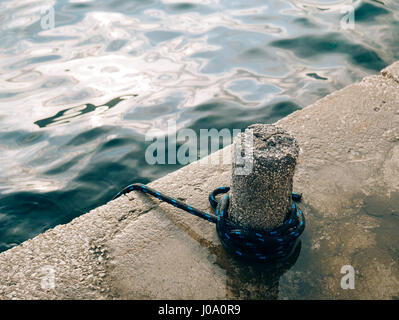 Mooring post on the beach Stock Photo