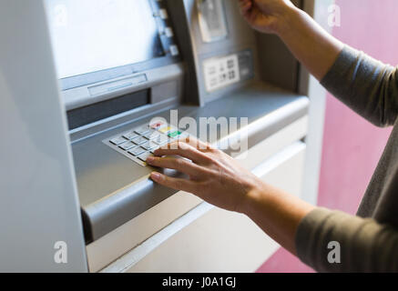close up of hand entering pin code at atm machine Stock Photo