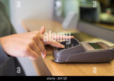 close up of hand entering code to money terminal Stock Photo