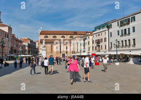 VENICE, ITALY - SEPTEMBER 23, 2016: Unrecognized people walk around Campo Santo Stefano square with Nicolo Tommaseo monument and Santo Stefano church. Stock Photo