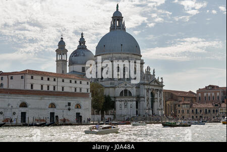 VENICE, ITALY - SEPTEMBER 23, 2016: People visit Basilica Santa Maria della Salute in Dorsoduro district. Venice is one of world most popular tourist  Stock Photo