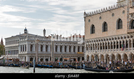 VENICE, ITALY - SEPTEMBER 23, 2016: A crowd of unrecognized tourists walk in front of Doge Palace. Venice is one of the world most popular tourist des Stock Photo