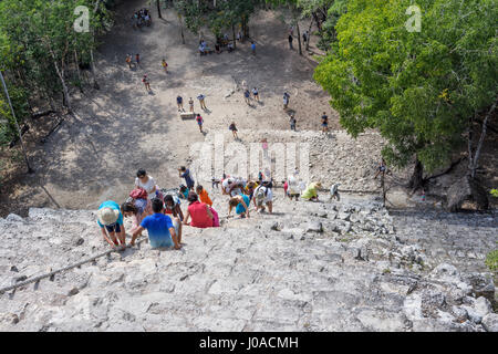 top view of tourists climb the Pyramid Nohoch Mul along the guiding rope at the Mayan Coba Ruins, Mexico Stock Photo