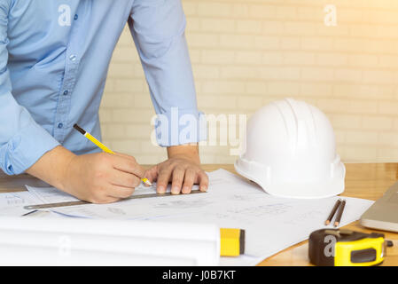 architect drawing architectural project on blueprint, engineering concept, architecture concept, soft focus, vintage tone Stock Photo
