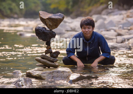 YASUKAWA VALLEY, JAPAN: INCREDIBLE pictures and video have captured the gravity-defying feats of one man who calls himself a rock balancing artist. The amazing footage shows increasingly larger rocks being balanced on smaller stones at near impossible angles. The mind-bending structures seem to abandon the laws of physics as the artist slowly but surely balances rocks in a seemingly unnatural manner. The footage was taken in Yasukawa Valley, Japan by local rock balancing artist Kokei Mikuni (30) from At Yuasa-Cho. Stock Photo