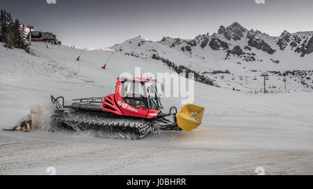 Piste Basher at Work in the Ski Resort of Courchevel in the 3 Valleys Les Trois Vallées of France Stock Photo