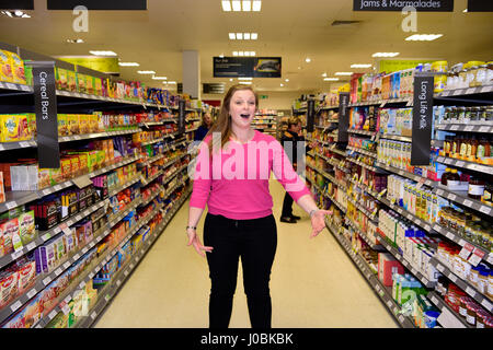 Female, part of a flash mob, singing opera in Waitrose supermarket, Alton, Hampshire, UK. 25.03.2017. Stock Photo