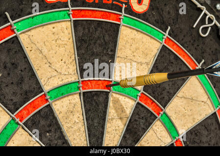 A dart in the treble twenty of a UK dart board Stock Photo