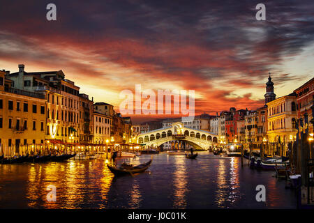 Ponte Rialto and gondola at sunset in Venice, Italy Stock Photo