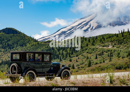 Beautifully restored Vintage American car passing Mount St. Helens, Pacific Northwest region, Washington States, USA Stock Photo