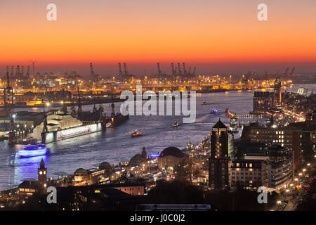View over St. Pauli district and St. Pauli Landungsbruecken pier over the harbour at sunset, Hamburg, Hanseatic City, Germany Stock Photo