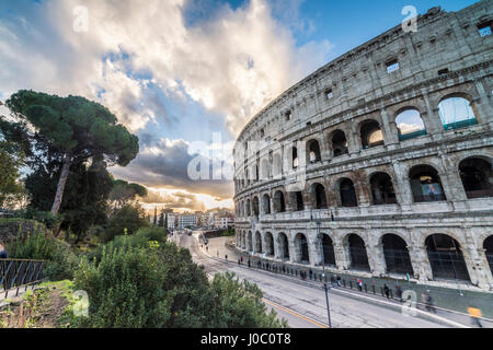 The pink sky at sunrise frames the ancient Colosseum (Flavian Amphitheatre), UNESCO World Heritage Site, Rome, Lazio, Italy Stock Photo