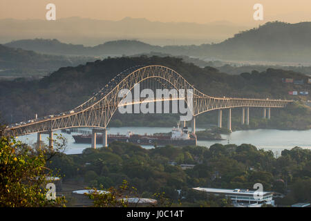 Cargo boat passes the Bridge of the Americas on the Panama Canal, Panama City, Panama, Central America Stock Photo