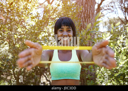 Portrait of young in rural setting, exercising using resistance band Stock Photo