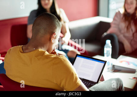 University student using laptop, relaxing with student friends Stock Photo