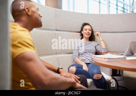 University students relaxing in modern seating area Stock Photo