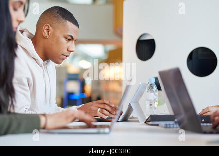 University students using laptops and digital tablet, working together Stock Photo