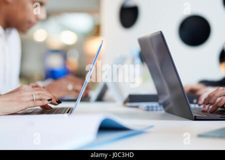 University students using laptops and digital tablet, working together Stock Photo