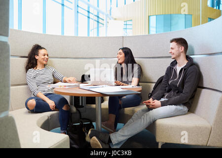 University students relaxing in modern seating area Stock Photo