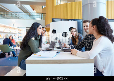 University students using laptops and digital tablet, working together Stock Photo