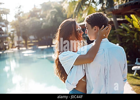 Romantic young couple embracing at poolside, Koh Samui, Thailand Stock Photo