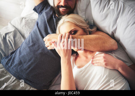 Couple relaxing on bed, fooling around Stock Photo