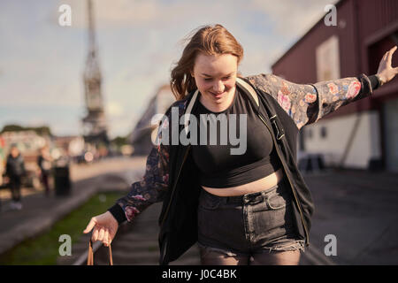 Young woman balancing on train track, Bristol, UK Stock Photo