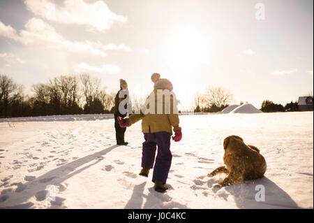 Children playing with their golden retriever, Lakefield, Ontario, Canada Stock Photo