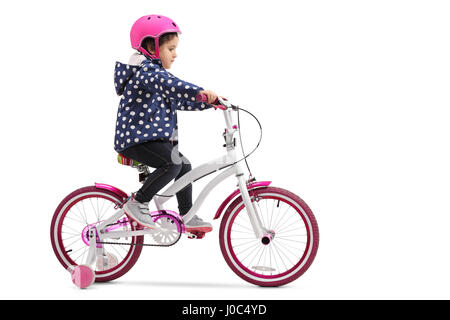 Cute little girl riding a bike isolated on white background Stock Photo