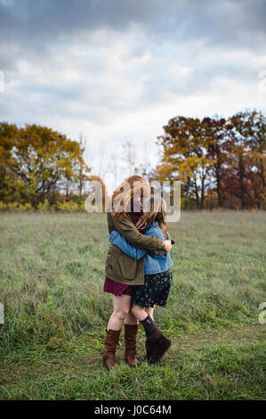 Mother and daughter hugging in meadow, Lakefield, Ontario, Canada Stock Photo