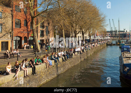 Young people enjoying the evening sunshine at Saint Augustine's Reach quayside, Bristol. Stock Photo