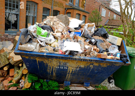 large builders skip in house front garden, norfolk, england Stock Photo