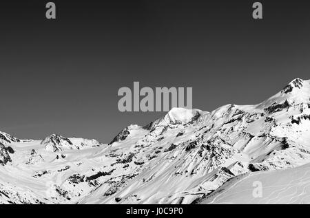 Black and white panoramic view on off-piste slope and snow mountain at sun winter day. Caucasus Mountains, Georgia, region Gudauri. Stock Photo