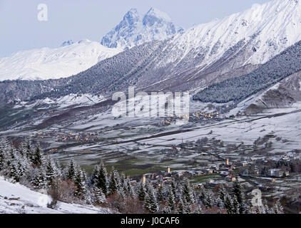 Tower villages in Upper Svaneti region of North Georgia with Mount Ushba's twin Caucasus Mountains peaks. Stock Photo