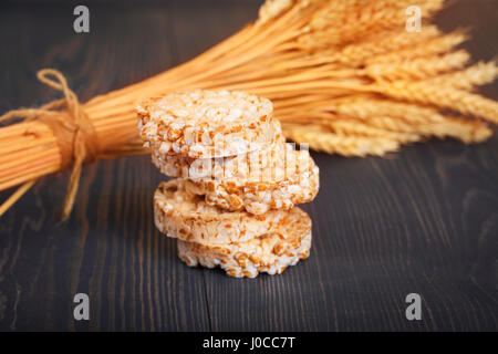 Dietary a low caloric grain crackers on a dark wooden background. Stock Photo