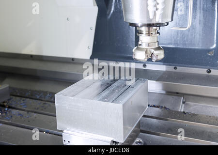 The face milling tool with the raw material work piece on the CNC milling machine.The spindle with holder and tooling for face milling on CNC milling  Stock Photo