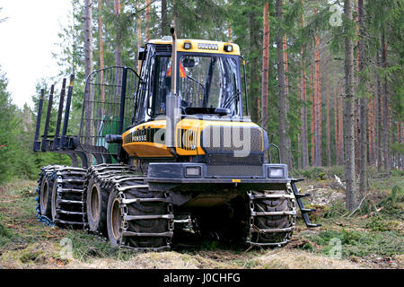 HUMPPILA, FINLAND - APRIL 9, 2017: PONSSE Elk forest forwarder in coniferous forest at spring. The Elk has the load carrying capacity of 13 000 kg. Stock Photo