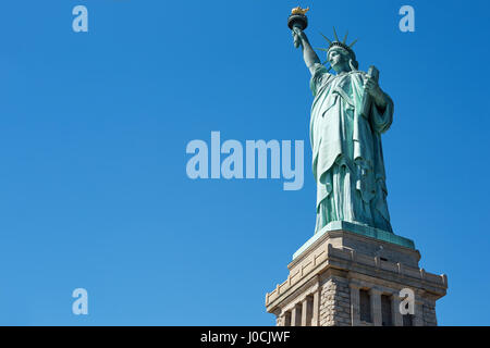 Statue of Liberty on clear blue sky in a sunny day, low angle view with clipping path Stock Photo