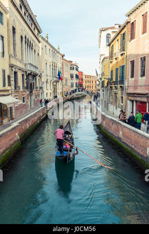 Gondola floating in a narrow canal in Venice, Italy Stock Photo