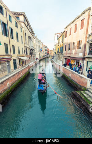 Gondola floating in a narrow canal in Venice, Italy Stock Photo