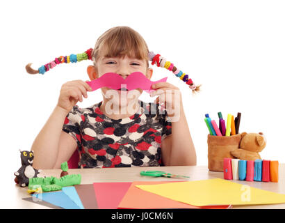 little girl makes paper mustache Stock Photo
