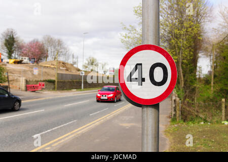 Urban 40 miles per hour speed limit sign used in the United Kingdom with defocussed traffic in the background Stock Photo