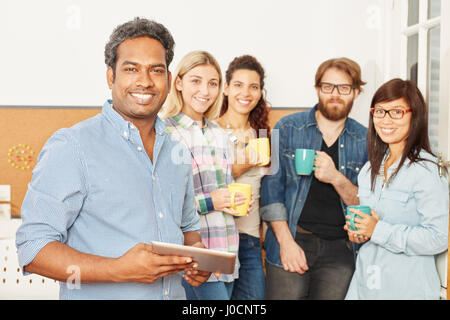Students as business people in a group enjoying their coffee break Stock Photo