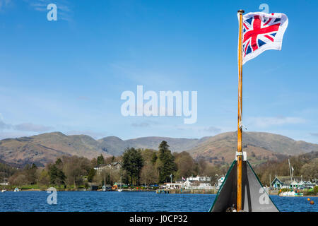 The Pilot Jack (Union Flag with surrounding white border) flying on a boat traveling on Lake Windermere in the Lake District, UK. Stock Photo