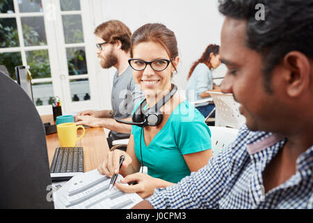 Collegues as service operators in call center Stock Photo