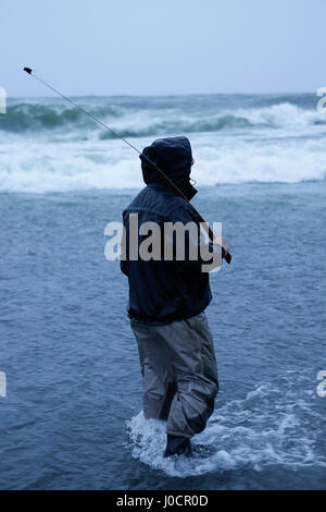 A member of the Yurok Indian Tribe fishes for lamprey at the mouth of the Klamath River on the Pacific Ocean on March 23, 2015. Yurok Indian Reservati Stock Photo