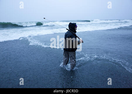A member of the Yurok Indian Tribe fishes for lamprey at the mouth of the Klamath River on the Pacific Ocean on March 23, 2015. Yurok Indian Reservati Stock Photo
